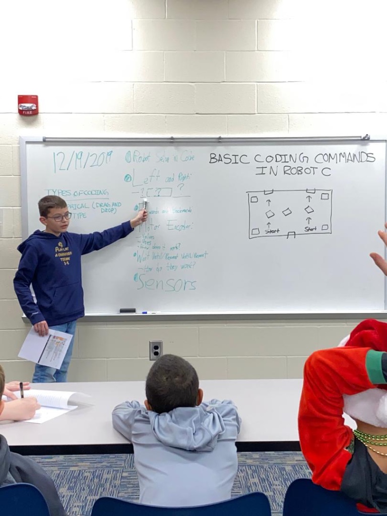 Picture of Killian  teaching Cedarville autonomous code.